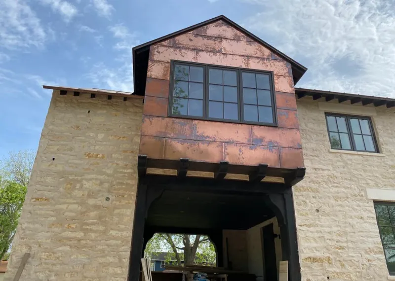 Copper metal panel facade on a stone building for Skylight Installation in Caldwell